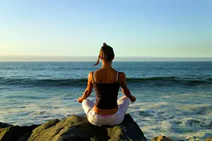 Meditation Prints: Woman pratice Yoga at sunrise on the beach, Vina del Mar, Chile