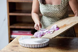 Vegetables Prints: Woman preparing red onions for onion pesto