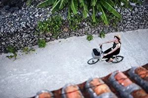 Bike Prints: Woman rides bike in Taketomi Island, Okinawa Prefecture, Japan