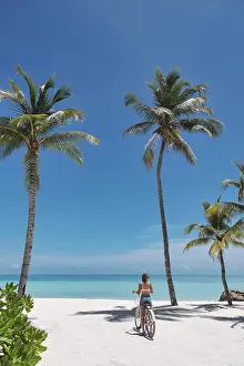 Bikini Prints: Woman riding bicycle on the beach
