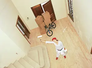 Woman with roller in new home