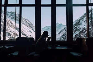Santiago Prints: A woman sips hot tea overlooking the snowy mountains in Chile