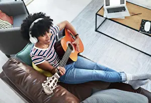 Notes Prints: Woman, song and passion with guitar at home for music