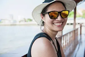 Beautiful Woman Prints: Woman taking a river cruise on Bangkok's Chao Phraya river