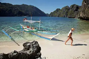 Visitor Prints: A Woman Tourist Wearing A Sun Hat And Bikini Walks Past A Bangka Boat Of Matinloc Island Near El Nido And Corong Corong