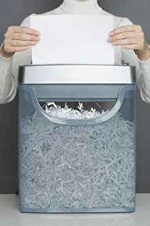 Secure Prints: Woman using a paper shredder