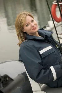 : Woman wearing foul weather gear preparing to go fishing MR-0423 PR-0424