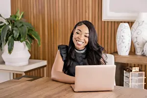 Mixed Prints: Woman working at desk in office using a laptop