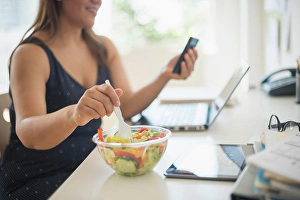 Heavy Prints: Woman working in home office and eating salad