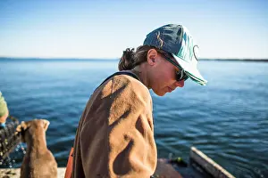 New England Prints: Woman working on shellfishing boat on Narragansett Bay