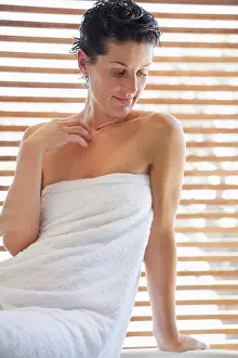 Mature Women Prints: Woman wrapped in a towel in bathroom