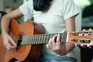 Sound Prints: woman's hands playing acoustic guitar, close up