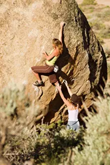 Adrenaline Prints: Two women climb at the Buttermilk boulders near Bishop Eastern Sierra, California, USA