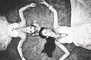 Attractive Prints: Two Women in Fashionable Dresses Laying on Ground, High Angle View