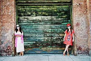 Chic Prints: Women leaning on loading dock wearing skull face paint