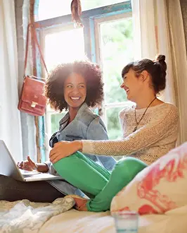 Worldwide Web Prints: Women relaxing together in bedroom