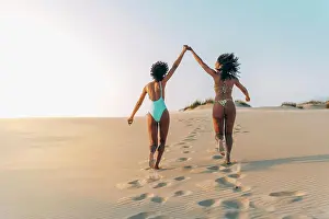 Anonymous Prints: Women walking in love on beach