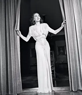 1946 Prints: Women's fashion in the 1940s. A young woman in a typical 1940s outfit