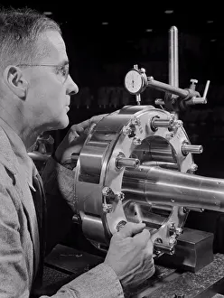 Manufacturing Prints: Worker Carefully Checking an Airplane Propeller Shaft for Concentricity at Manufacturing Plant