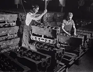 Manufacturing Prints: Two Workers Putting Engine Blocks for the Army's Half-Track Scout Car on Assembly Line at Factory Converted to War