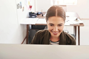 Businesswomen Prints: Working hard to achieve success. a young businesswoman working in her office