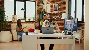 Financial Prints: Young adult sitting at desk to work on freelance with laptop