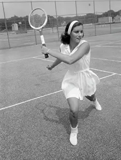 One Young Woman Only Prints: Young attractive woman playing tennis at tennis court