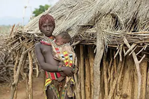 East Africa Prints: Young black girl with baby of the Hamar