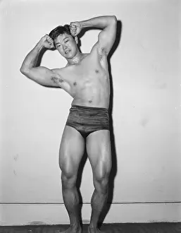 Bodybuilder Prints: Young Bodybuilder Flexes Biceps c, 1956