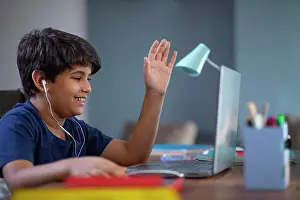 Home Prints: Young boy attending online class on his laptop during lockdown
