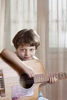 4 5 Years Prints: A young boy holding an acoustic guitar