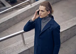 Network Prints: From above of serious young businessman in elegant coat checking message on mobile phone while standing on stone