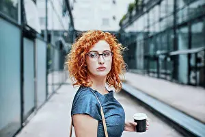 Beverage Prints: Young businesswoman holding take out coffee