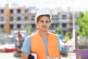 Technician Prints: young construction engineer with helmet working outside