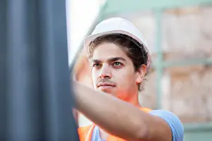 Technician Prints: young construction engineer with helmet working outside