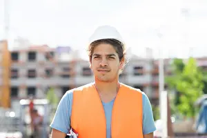 Technician Prints: young construction engineer with helmet working outside
