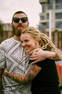 Hugging Prints: A young couple in love hugs and kisses