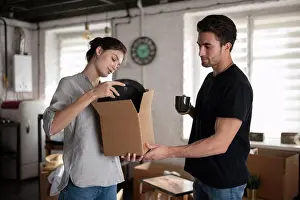 Property Prints: Young couple unpacking plates during relocation