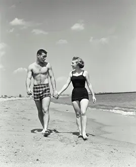 Talk Prints: Young couple walking on beach