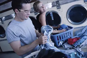Rolled Up Sleeves Prints: Young couple working in a laundromat