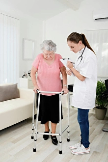 Disability Prints: Young doctor checking rehab medical progress to elderly woman at home