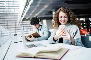Campus Prints: Young female student in library