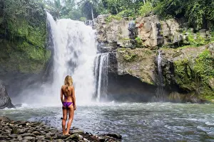 Full Length Prints: Young girl in bikini next to Tegenungan Waterfall; Ubud, Bali, Indonesia