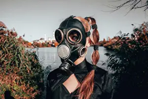 Dangerous Prints: young girl in a gas mask in a red dress with a book in her hands against the background of smoking factory chimneys