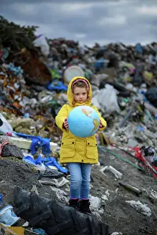 Activist Prints: Young girl holding planet Earth model