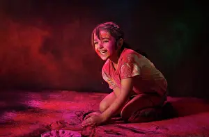 Holi Prints: Young girl playing with gulal on Holi