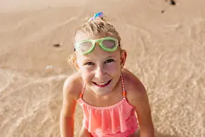 Unschuld Prints: Young girl playing, swiming and splashing in fresh sea water