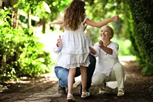 Baby Boomer Prints: Young girl runs towards her grandparents on a quiet country road