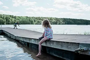 Parenting Prints: young girl watching her brother fish at the beach