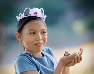 Oneperson Only Prints: Young girl wearing a crown and holding a green frog in her hands